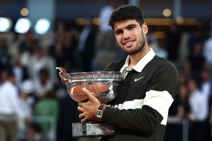 Spain's Carlos Alcaraz holds the French Open trophy after