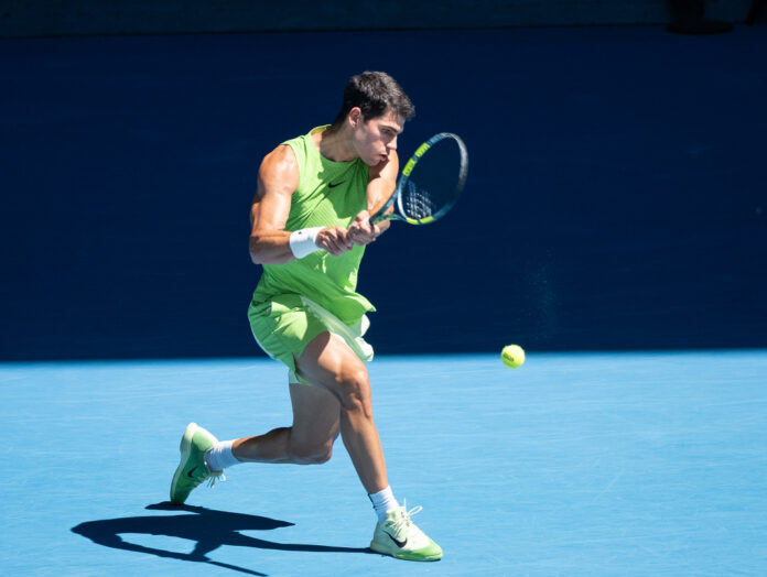 Carlos Alcaraz of Spain hits a return in the men's singles semi-final match