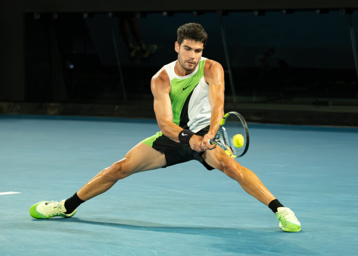 Carlos Alcaraz of Spain Returns a ball at the Australian Open 2026