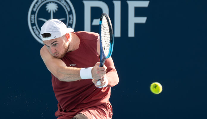 Jack Draper of Great Britain returns a shot at Miami Open 2026