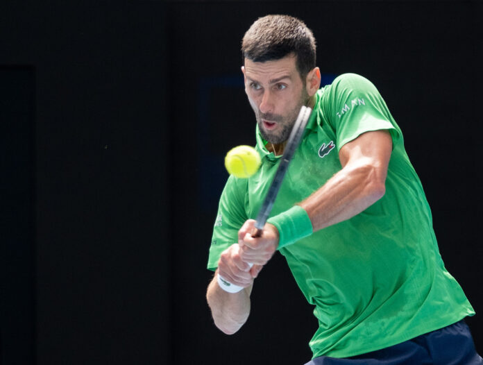 ovak Djokovic hits a return at the 2026 Australian Open in Melbourn