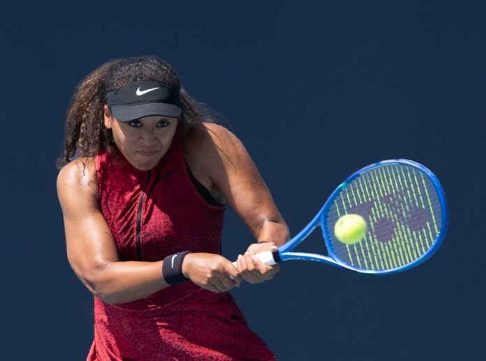Naomi Osaka of Japan returns a shot against Talia Gibson of Australia during the Miami Open