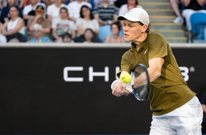 Jannik Sinner hits a return at the Australian Open