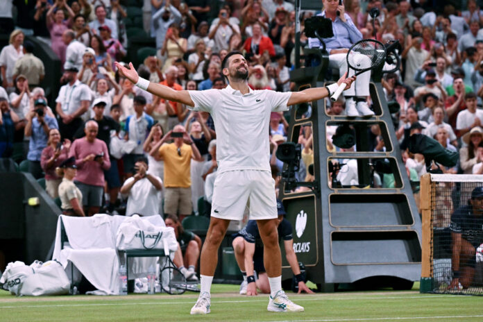Serbia's Novak Djokovic celebrates winning at Wimbledon