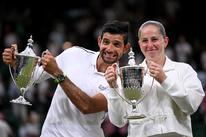 El Salvador's Marcelo Arevalo and Latvia's Jelena Ostapenko pose with their Wimbledon Mixed Doubles winners trophie