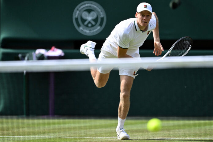 Jannik Sinner serves on the grass of Centre Court at Wimbledon 2026