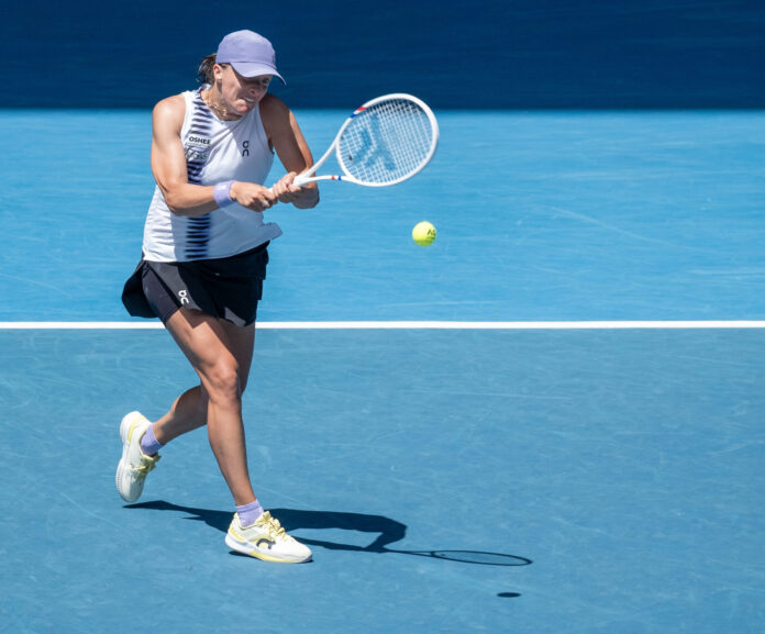 Iga Swiatek hits a strong return at the Australian Open
