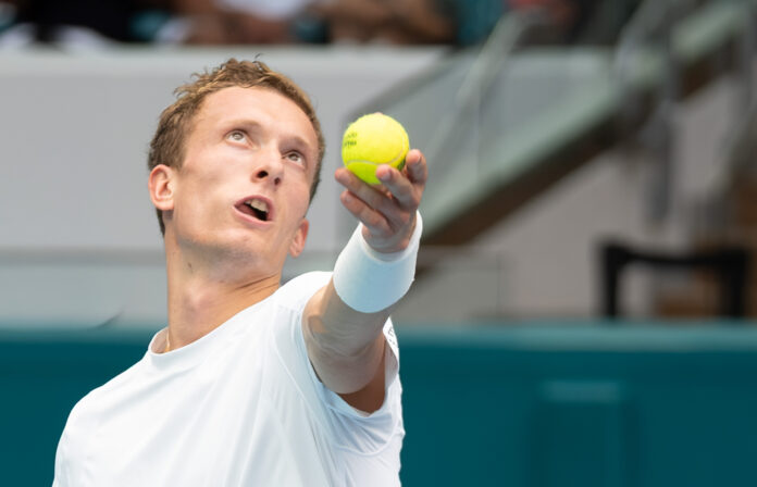 Lehecka serves at the Miami Open against Jannik Sinner