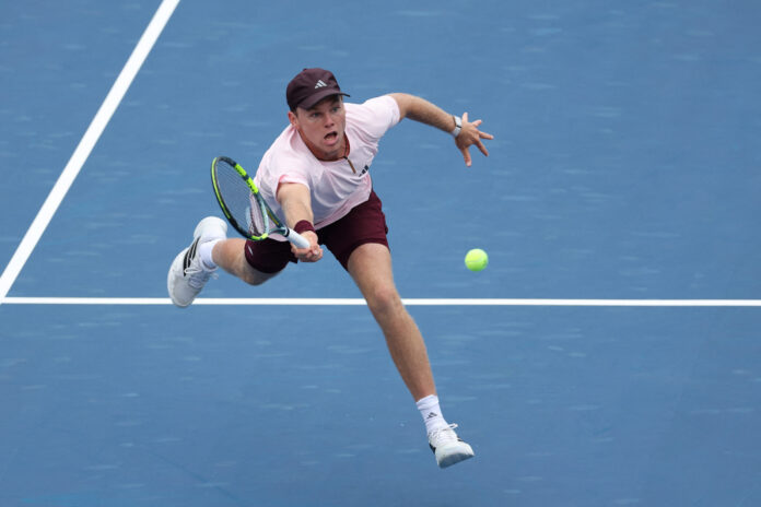 Alex Michelsen of the United States returns a shot at the US Open 2026