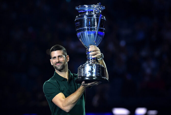 Serbia's Novak Djokovic holds the 2023 Year-End Number one trophy