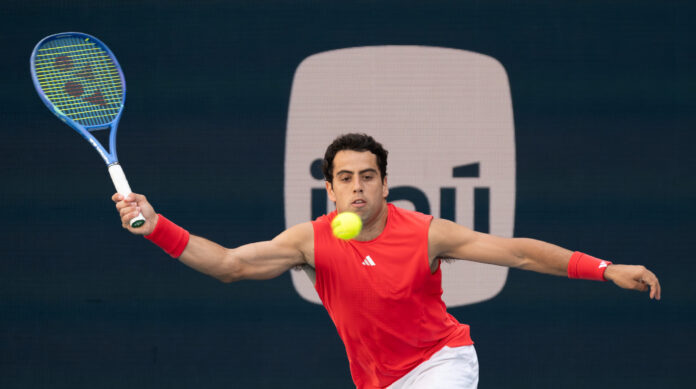 Jaume Munar of Spain hits a return at the Miami Open
